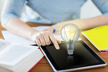 Image showing close up of student with light bulb on tablet pc