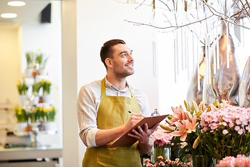 Image showing florist man with clipboard at flower shop