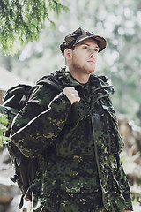 Image showing young soldier with backpack in forest