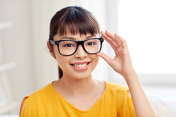 Image showing happy asian young woman in glasses at home