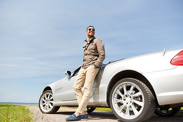 Image showing happy man near cabriolet car outdoors