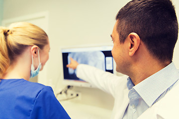 Image showing close up of dentist and assistant at dental clinic