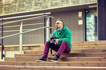 Image showing young hipster man with digital camera in city