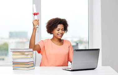 Image showing happy african woman with laptop, books and diploma