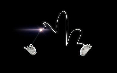 Image showing magician hands with magic wand showing trick