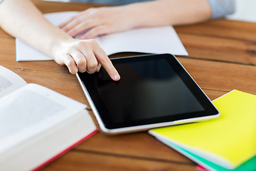 Image showing close up of student with tablet pc and notebook