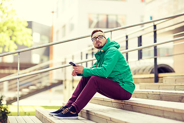 Image showing young hipster man with smartphone in city