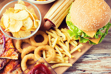 Image showing close up of fast food snacks on wooden table