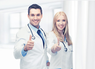 Image showing young team of two doctors showing thumbs up