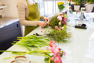 Image showing close up of woman making bunch at flower shop
