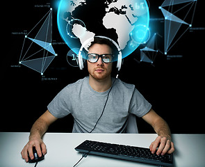 Image showing man in headset with computer over earth projection