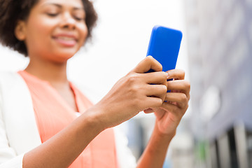 Image showing close up of african woman with smartphone in city