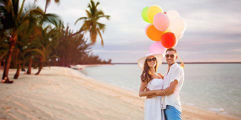 Image showing smiling couple with air balloons outdoors