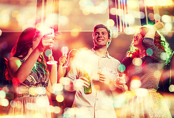 Image showing smiling friends with wine glasses and beer in club