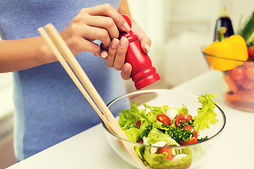 Image showing close up of woman cooking vegetable salad at home