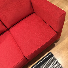 Image showing Classic red sofa on wooden floor