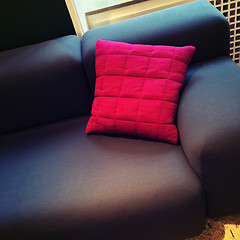 Image showing Fashionable sofa with bright red cushion