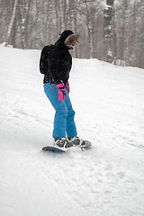 Image showing Woman doing exercise on snowboard