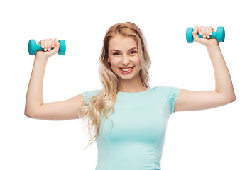 Image showing smiling beautiful young sporty woman with dumbbell