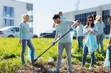 Image showing volunteers with garbage bags cleaning park area