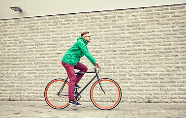 Image showing young hipster man riding fixed gear bike