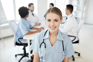 Image showing happy doctor over group of medics at hospital