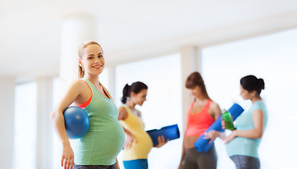 Image showing happy pregnant woman with ball in gym