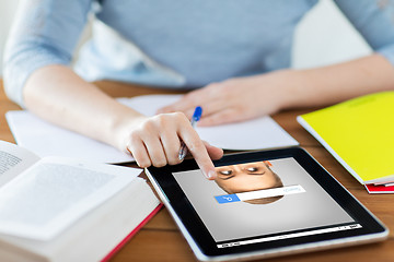 Image showing close up of student with tablet pc and notebook