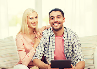 Image showing smiling happy couple with tablet pc at home