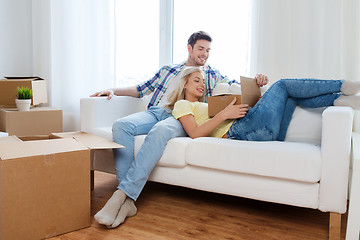 Image showing happy couple with big cardboard boxes at new home