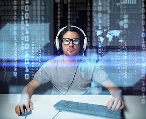 Image showing man in headset hacking computer or programming