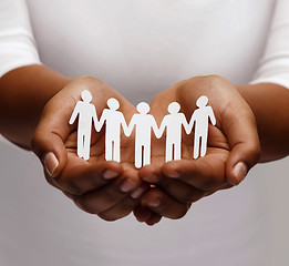 Image showing african american female hands with paper people