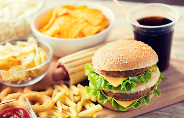 Image showing close up of fast food snacks and drink on table