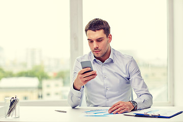 Image showing close up of businessman with smartphone