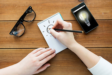 Image showing close up of woman or student writing to notepad