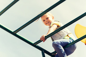 Image showing happy little girl climbing on children playground