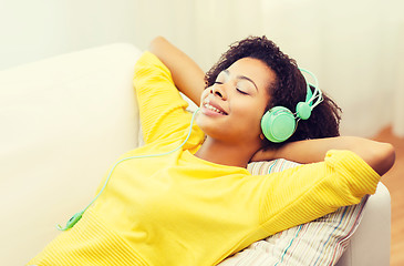 Image showing happy woman with headphones listening to music