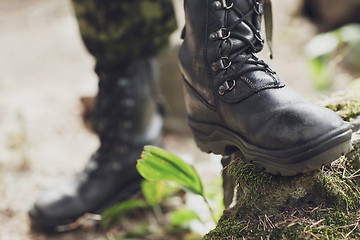 Image showing close up of soldier feet with army boots in forest