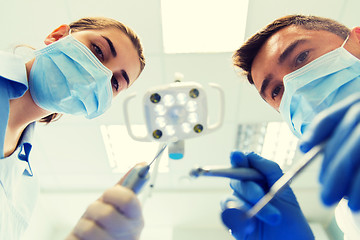 Image showing close up of dentist and assistant at dental clinic