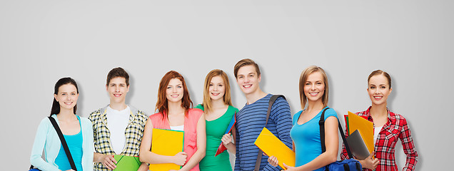 Image showing group of teenage students with folders and bags