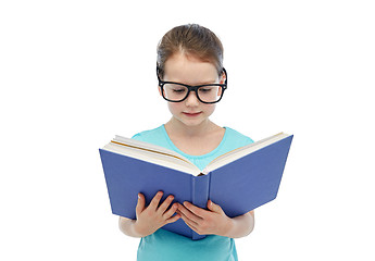 Image showing happy little girl in eyeglasses reading book
