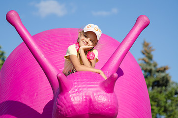 Image showing Moscow, Russia August 10, 2015: Six-year girl on a pink snail, exhibit ENEA in Moscow