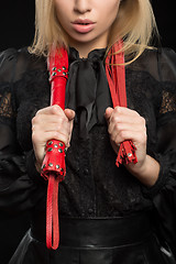 Image showing beautiful woman in biting red whip