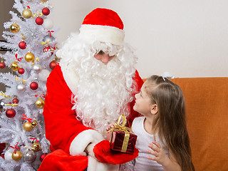 Image showing Santa Claus gives a gift a five-year girl