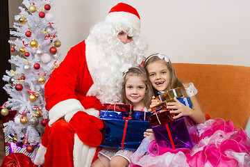 Image showing Santa Claus gave presents to the children and hugged