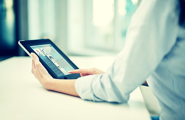 Image showing close up of woman hands with tablet pc at office