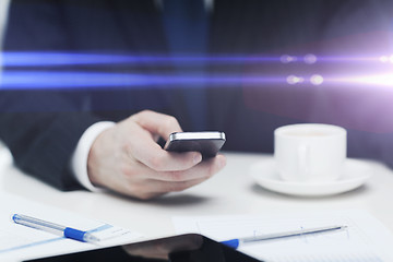Image showing businessman with smartphone reading news