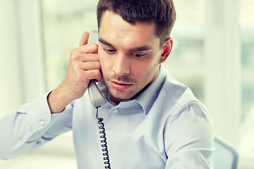 Image showing face of businessman calling on phone in office