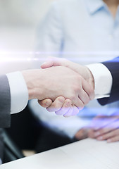 Image showing two businessmen shaking hands in office