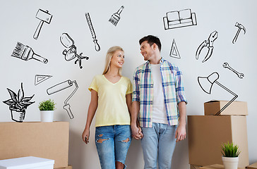 Image showing smiling couple with big boxes moving to new home